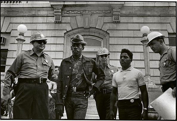 Danny Lyon Sheriff Jim Clark arrests two demonstrators who displayed placards on the steps of the federal building in Selma, 1963