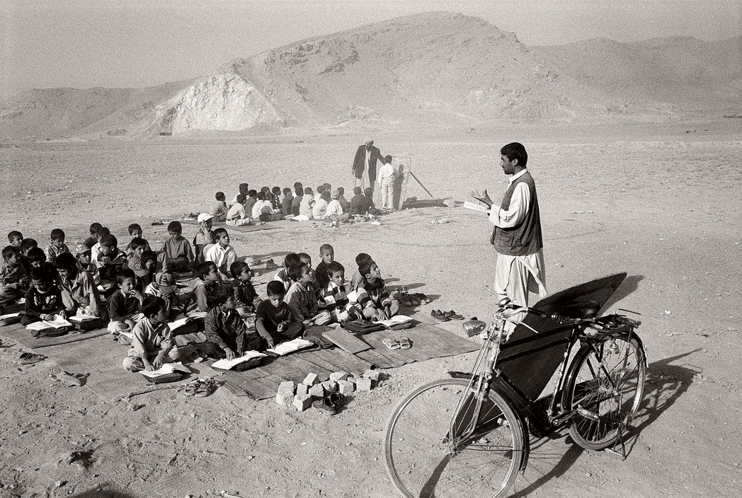 AFGHANISTAN. Tarakhil. Classes are held in the open for lack of space in a village school donated by Japan. The ground had to be demined first.