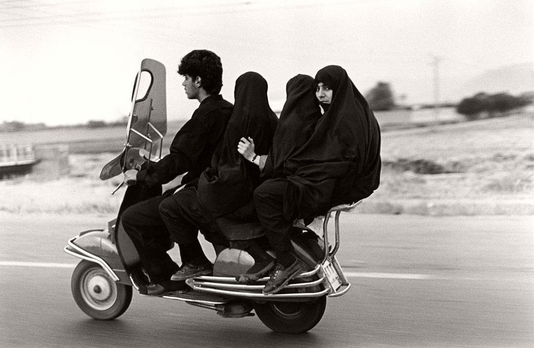 IRAN. Shahr Rey. Young man, three veiled girls in a four-seater motorbike. 1997.