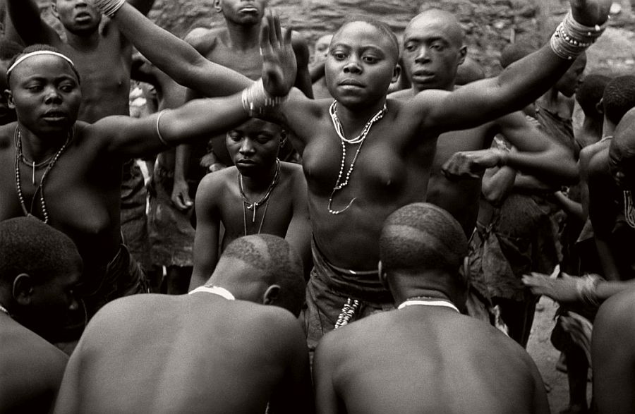 UGANDA. Pygmies. "Dance of the forest people". The Bachimbiri and Wagasero dance their own version of a courting dance, the "Kamundere", before a semi-circle of men of the tribes who kneel before them. 1948.
