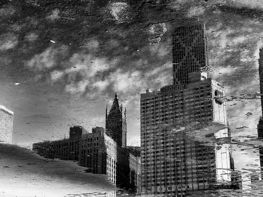 Cityscape reflected in puddles on Ohio Street Beach, Chicago