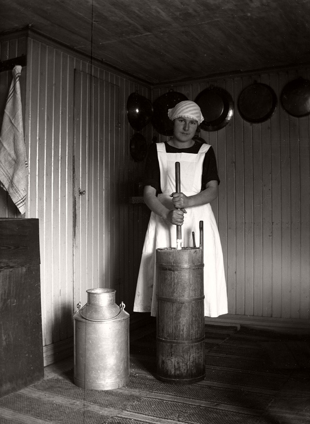Ulla Göransson churning butter in the old way, ca 1920.