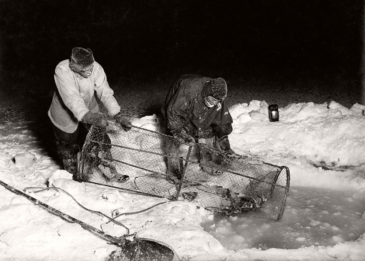 Expedition cook Thomas Clissold and surgeon Edward Atkinson (right) haul up a seal-baited fish trap during Antarctica's winter darkness.  The team's nearly three years of scientific experiments—particularly in meteorology and geology—laid the groundwork for what is known about the continent today, Jones said.  In addition to their drive to reach the Pole, he said, Scott and his men "were also driven by a passion to discover more about the world."