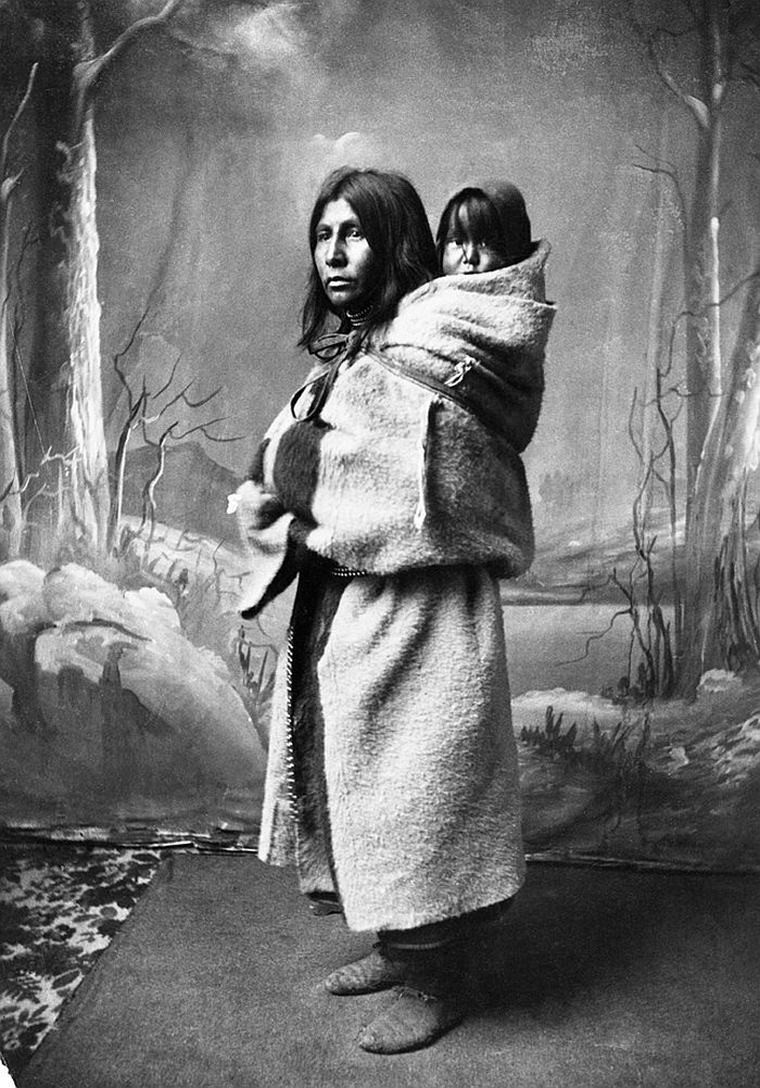 Blackfoot woman and baby on her back, 1886