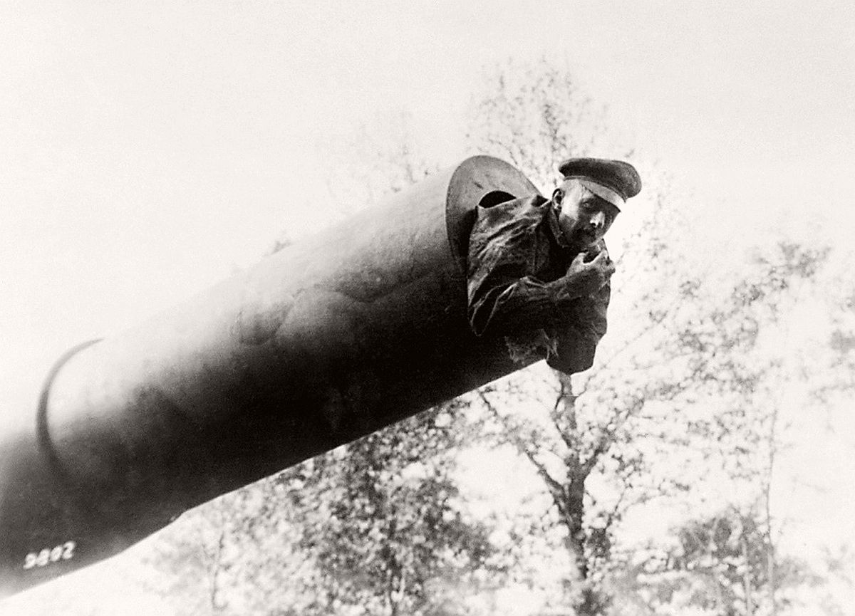   British soldier poses in mouth of a captured 38 caliber gun during World War I. # AP