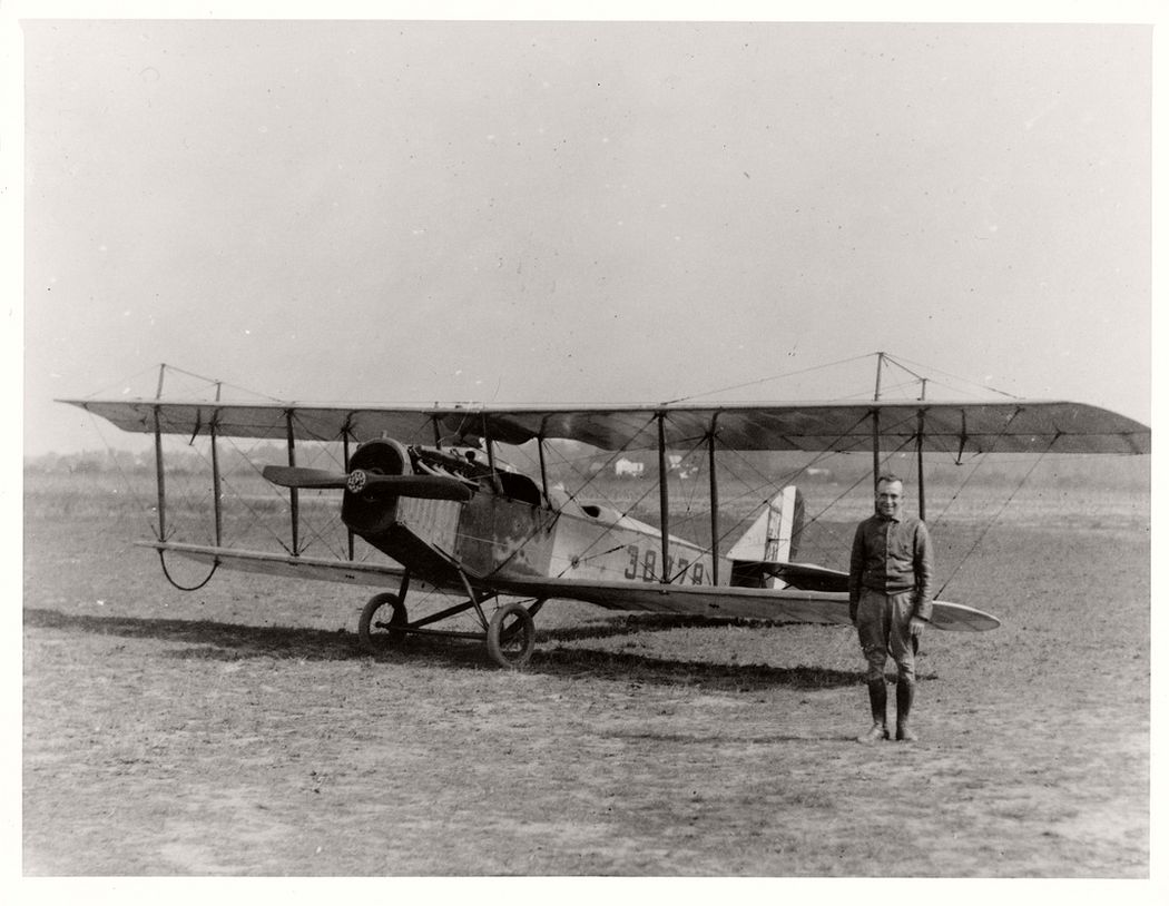 Pilot Eddie Gardner posing in front of an airmail plane, 1918