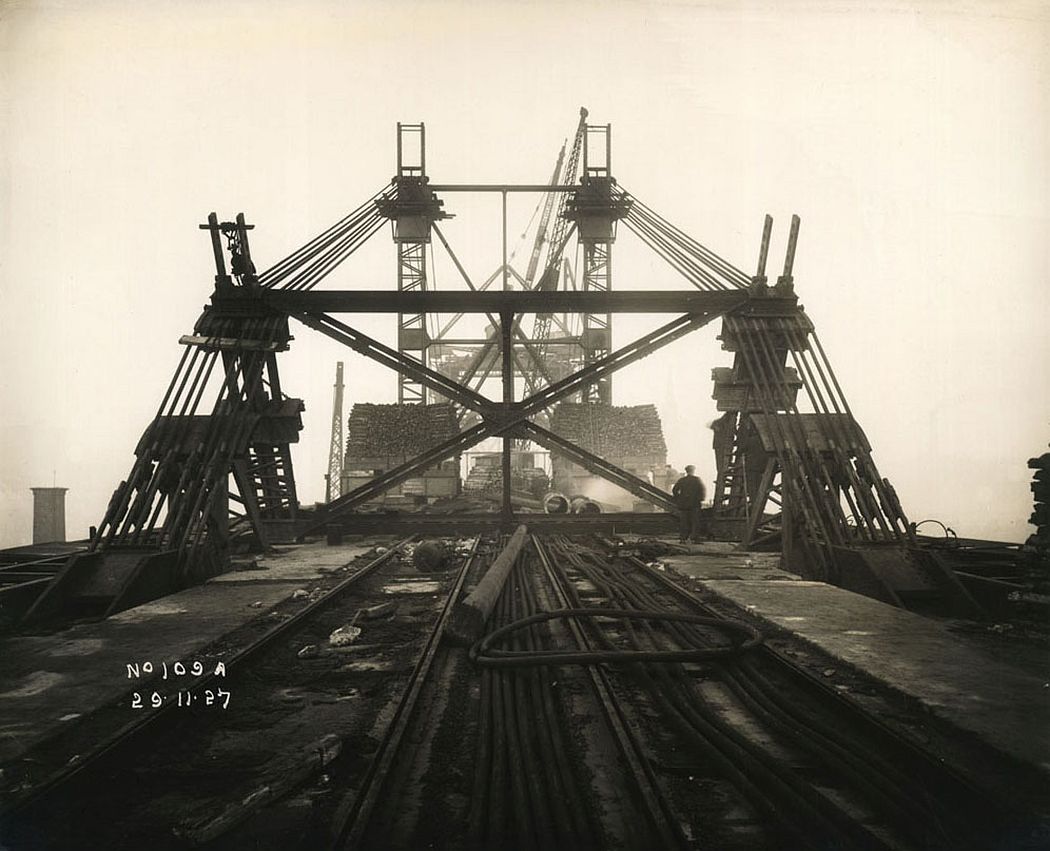 View of support mast and cables holding the Tyne Bridge in place as it is constructed, 29 November 1927