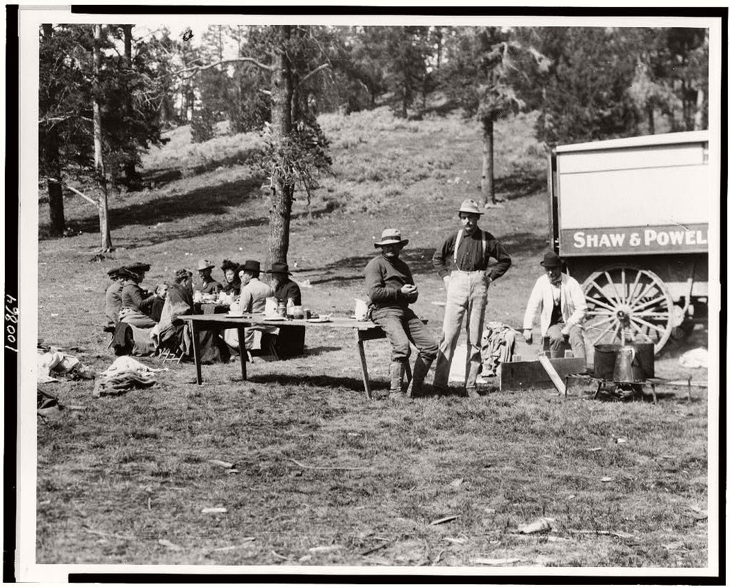 Tourists and guides picnicking in Yellowstone Park, 1903.