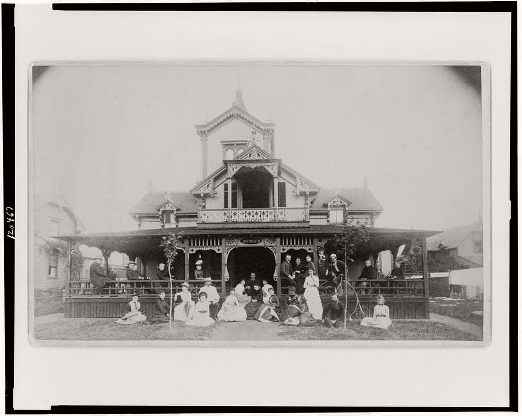 Frances Benjamin Johnston and family on porch and in front of house, between 1890 and 1910.