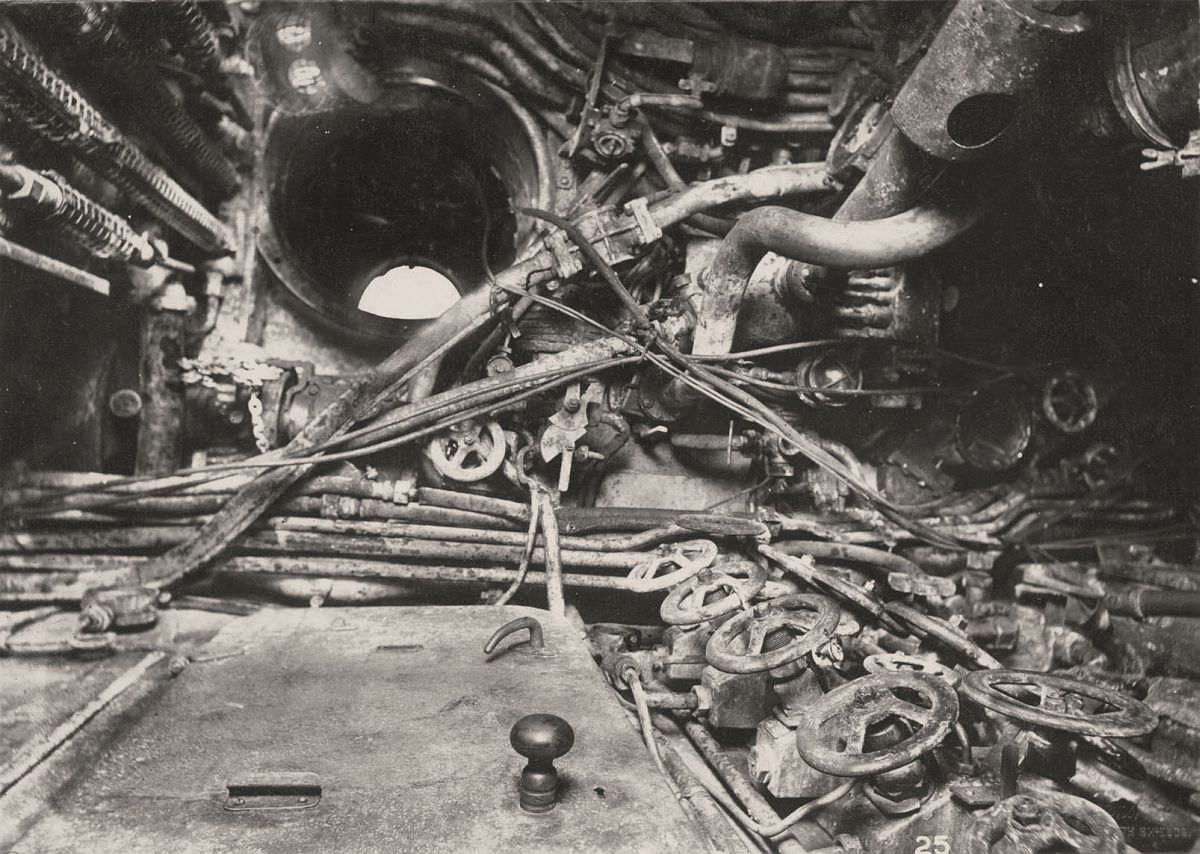 This photograph shows the U-Boat 110, a German Submarine that was sunk and risen in 1918. This photograph shows the Control Room and access scuttle to the conning tower.
