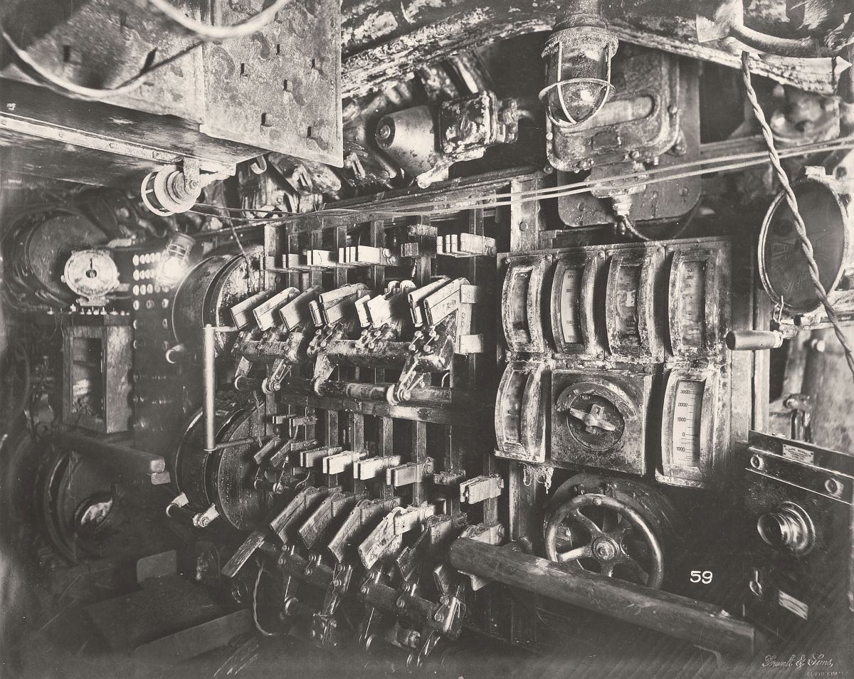 This photograph shows the U-Boat 110, a German Submarine that was sunk and risen in 1918. This photograph shows the Submarine's Electric Control Room and switch gear.