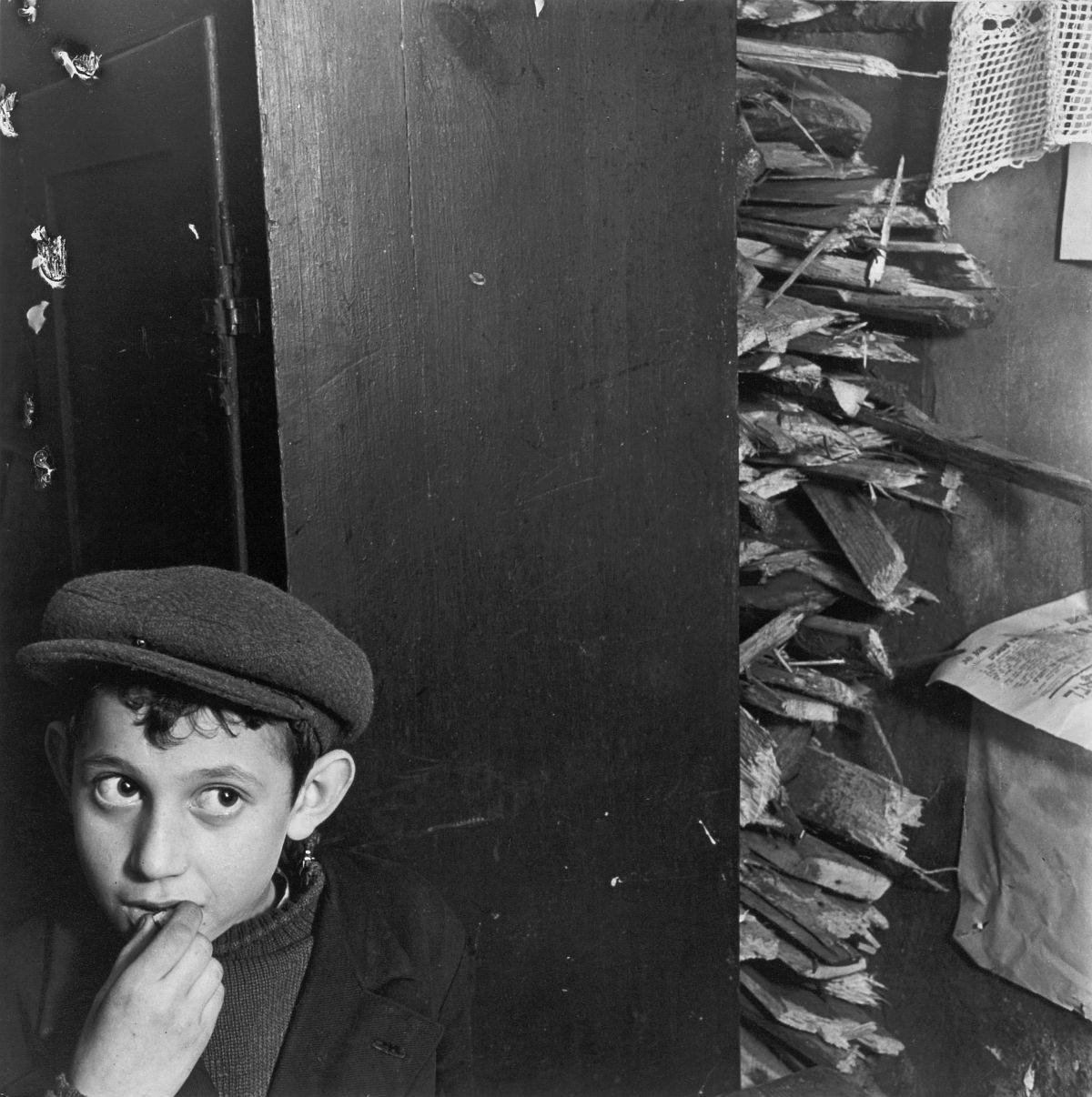 Roman Vishniac, [Boy with kindling in a basement dwelling, Krochmalna Street, Warsaw], ca. 1935–38. Gelatin silver print. © Mara Vishniac Kohn, courtesy International Center of Photography.