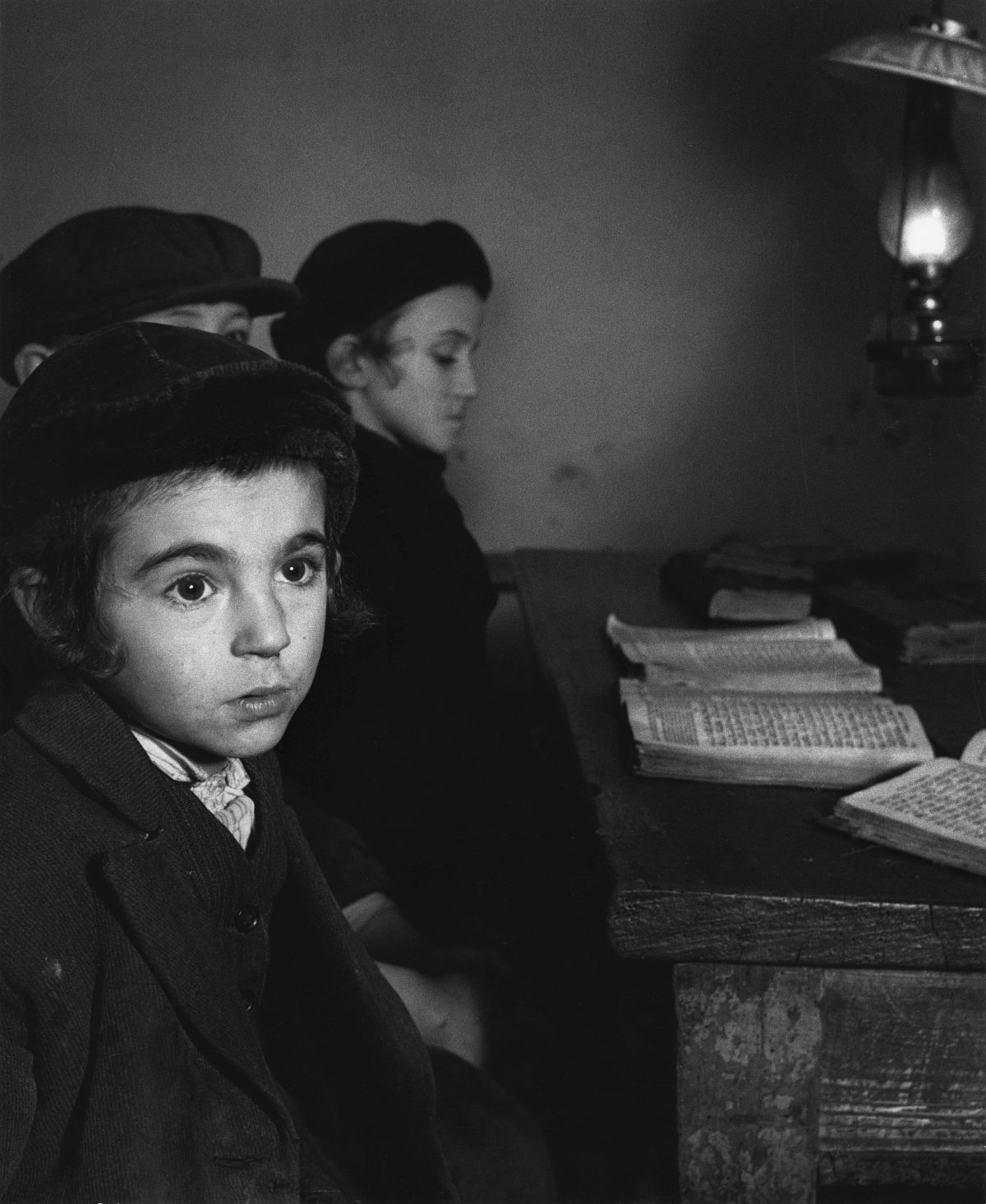 Roman Vishniac, [David Eckstein, seven years old, and classmates in cheder (Jewish elementary school), Brod], ca. 1938. Gelatin silver print. © Mara Vishniac Kohn, courtesy International Center of Photography. 