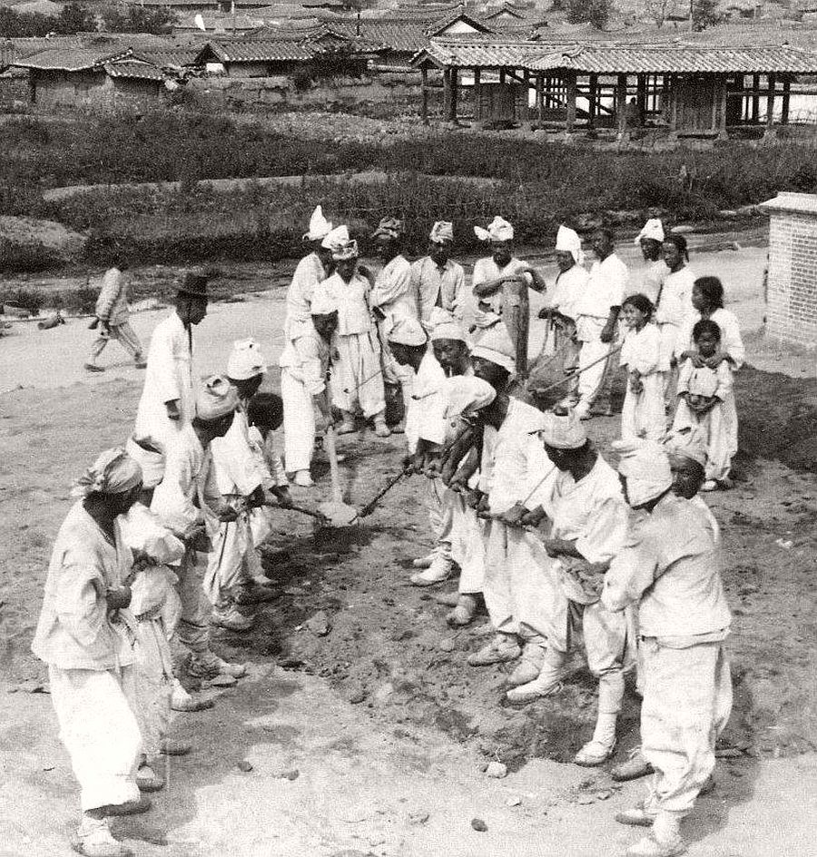 The human back-hoe laying the foundation for a new post office in Seoul, 1903