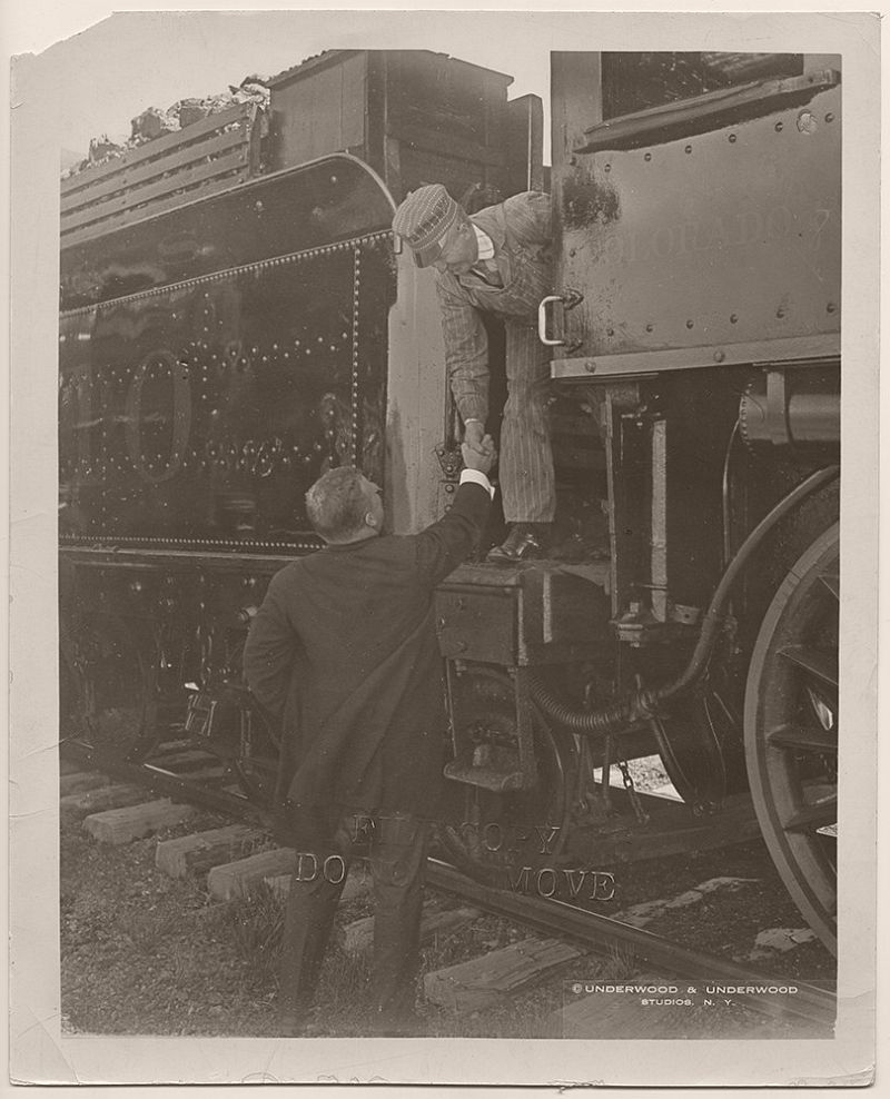 President Theodore Roosevelt shaking hands with a locomotive engineer for the Colorado and Southern Railway. Vernon, Wilbarger County, Texas. April 1905.