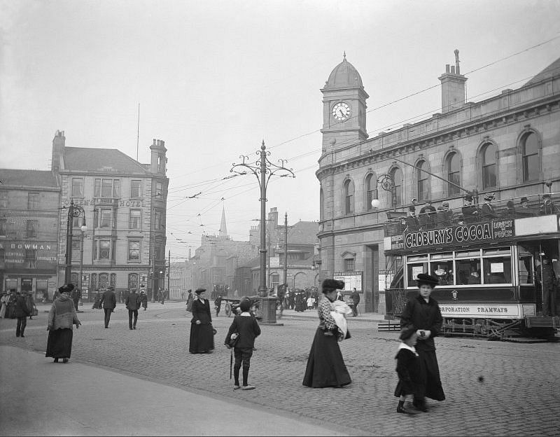 View of Leith Central Station, Edinburgh, from Leith Walk, with street scene and tram advertising Cadbury's Cocoa, 1912. The station opened in 1903 and closed for regular passenger traffic in 1952. Visible is also the Queen's Hotel.