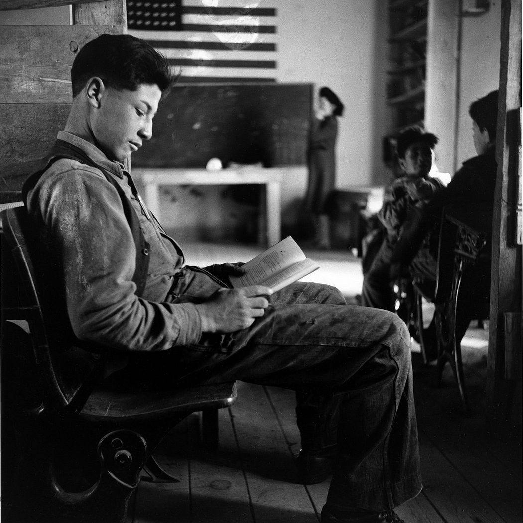 A boy reading in one-room school in an isolated mountainous Hispanic community, Ojo Sarco, New Mexico, 1943