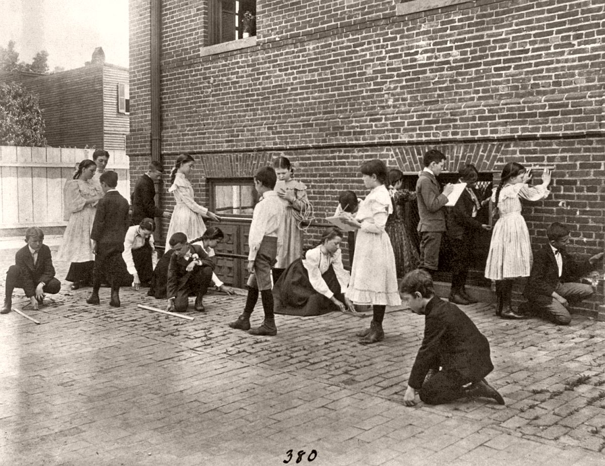 Students of 8th Division school using rulers, yardsticks, and measuring tape in school yard, Washington, DC, ca. 1899