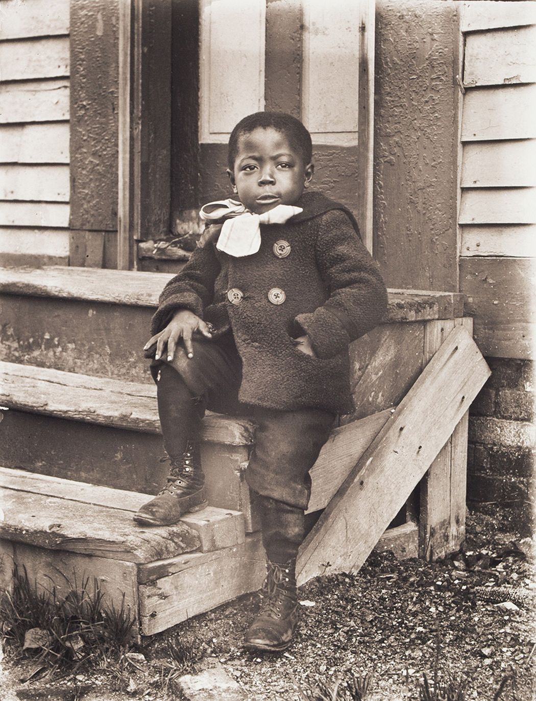 Portrait of Ralph Mendis on a Stoop, about 1902, printed 2016, archival inkjet print, E.132.16.8 Ralph Mendis was born in 1897 and is seen here at approximately age 5. His mother Francis was part of the New Bern, North Carolina, migration of blacks to Worcester, Massachusetts. His father was one of a handful of Jamaican immigrants who resided in the city. Rhode Island records from 1906 indicate that Ralph died as a child, though the cause is unknown.