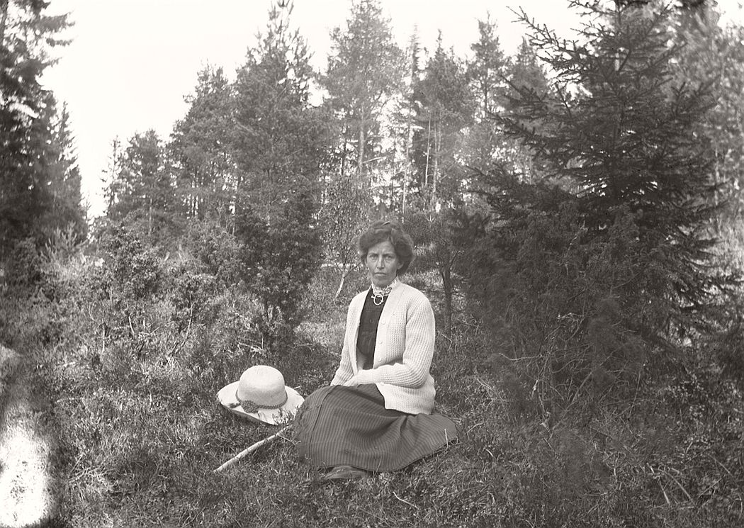 Woman sitting in the woods.