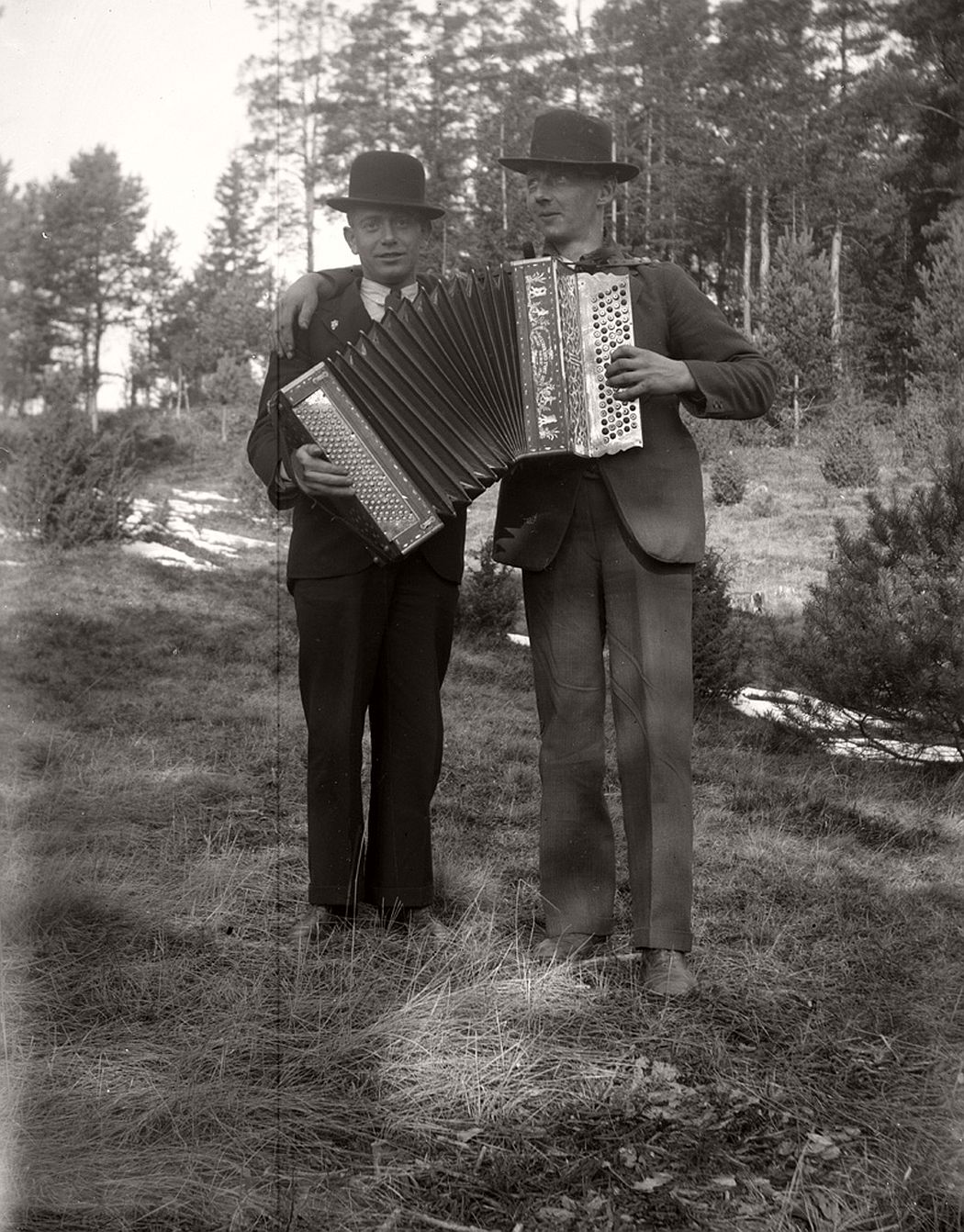 Two men with an accordion.