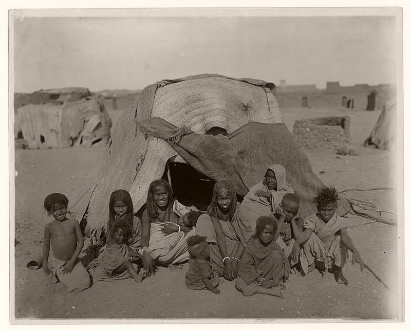 A group of Bisharin before their tent at Wady Halfa, Egypt