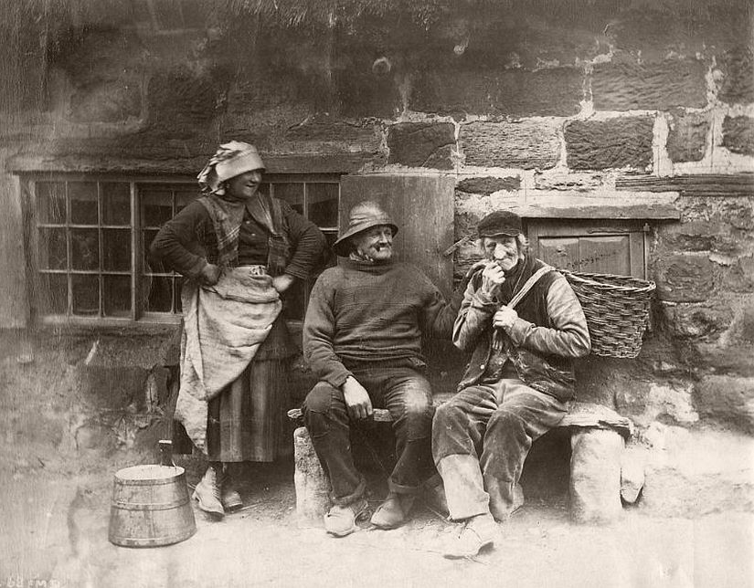 Portrait of three people outside a house