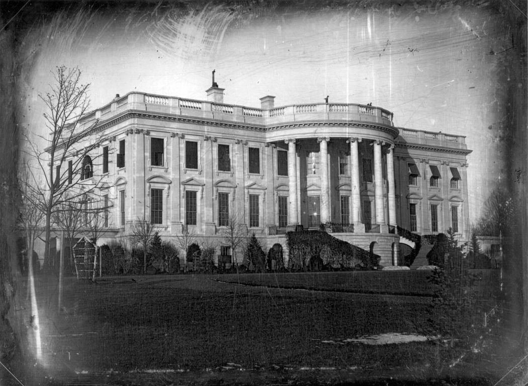 South view of the President's House looking north and east: earliest known photograph of the White House, c. January 1846, President Polk's first year in office. The cast of the shadows indicates that the photograph was taken in early morning light. Notice the barren trees, the patch of snow in the foreground and the piles of snow at the base of the staircase. (Image: John Plumbe, Jr./Library of Congress, via White House Historical Association)