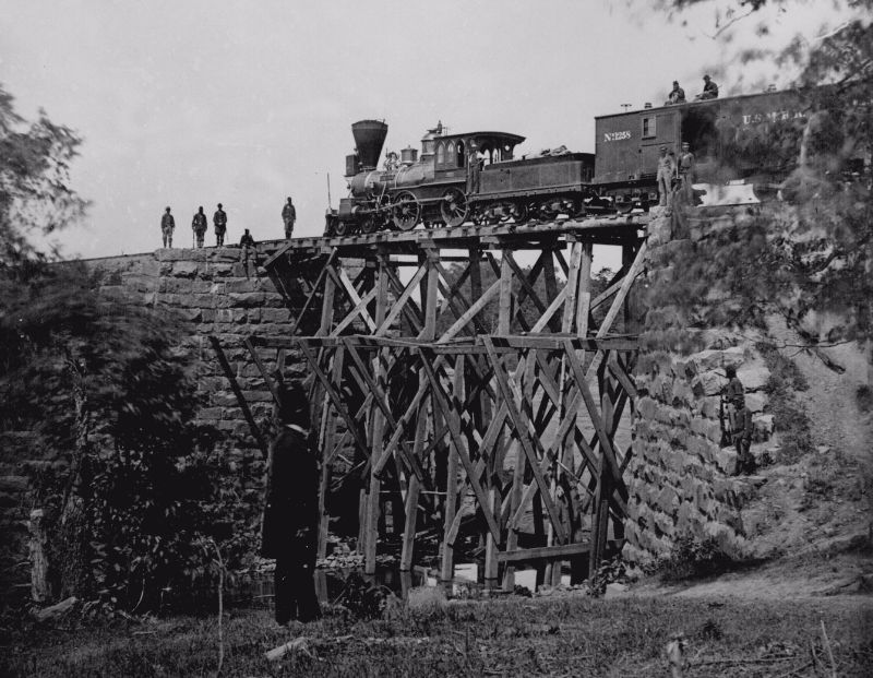 The engine "Firefly" on a trestle of the Orange and Alexandria Railroad, circa 1864.