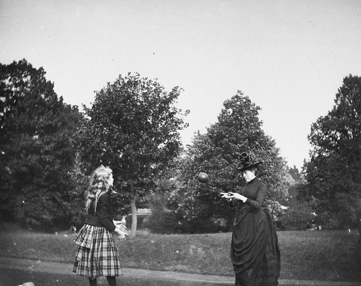 July 20, 1886 - Zelma Levison and her aunt Jo Grimwood throw a ball back and forth on a lawn in Prospect Park.