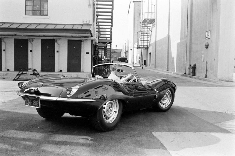 Steve McQueen in black Jaguar at studio, California, 1963 by John Dominis