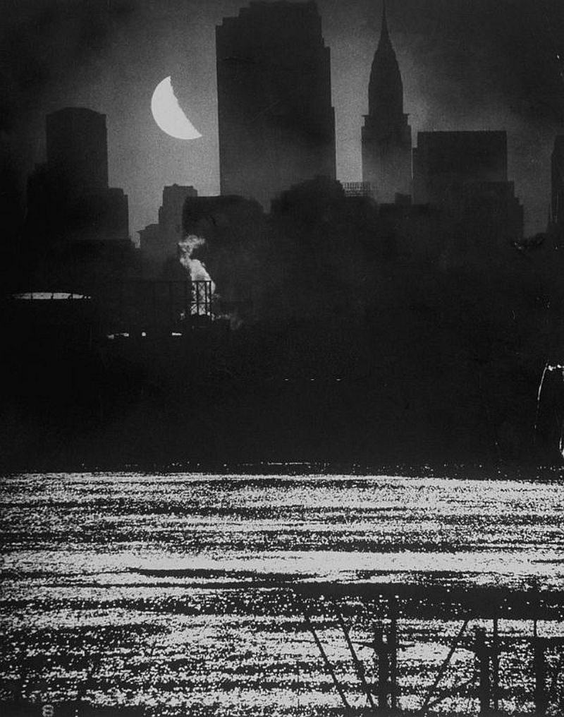 Moon shining over Manhattan's RCA & Chrysler buildings as its light shimmers on the waters of the Hudson River, 1946.