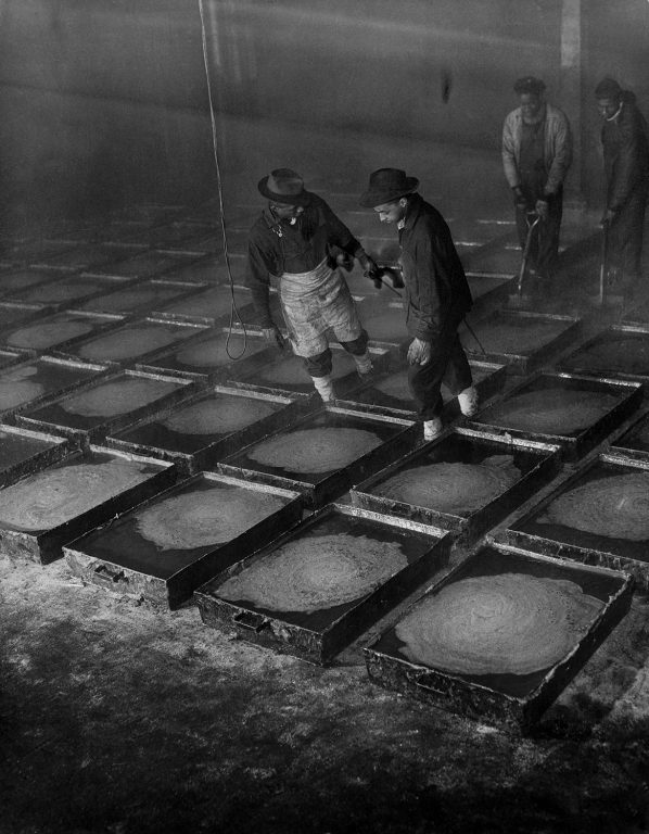Gordon Parks, Two workmen pulling pans of red hot grease that has just been poured from a cooking kettle. After it is cooled it can be lifted out in solid chunks and carried away on flat cars., 1944, Prints and Photographs Division, Library of Congress, Washington DC, Courtesy of the Gordon Parks Foundation