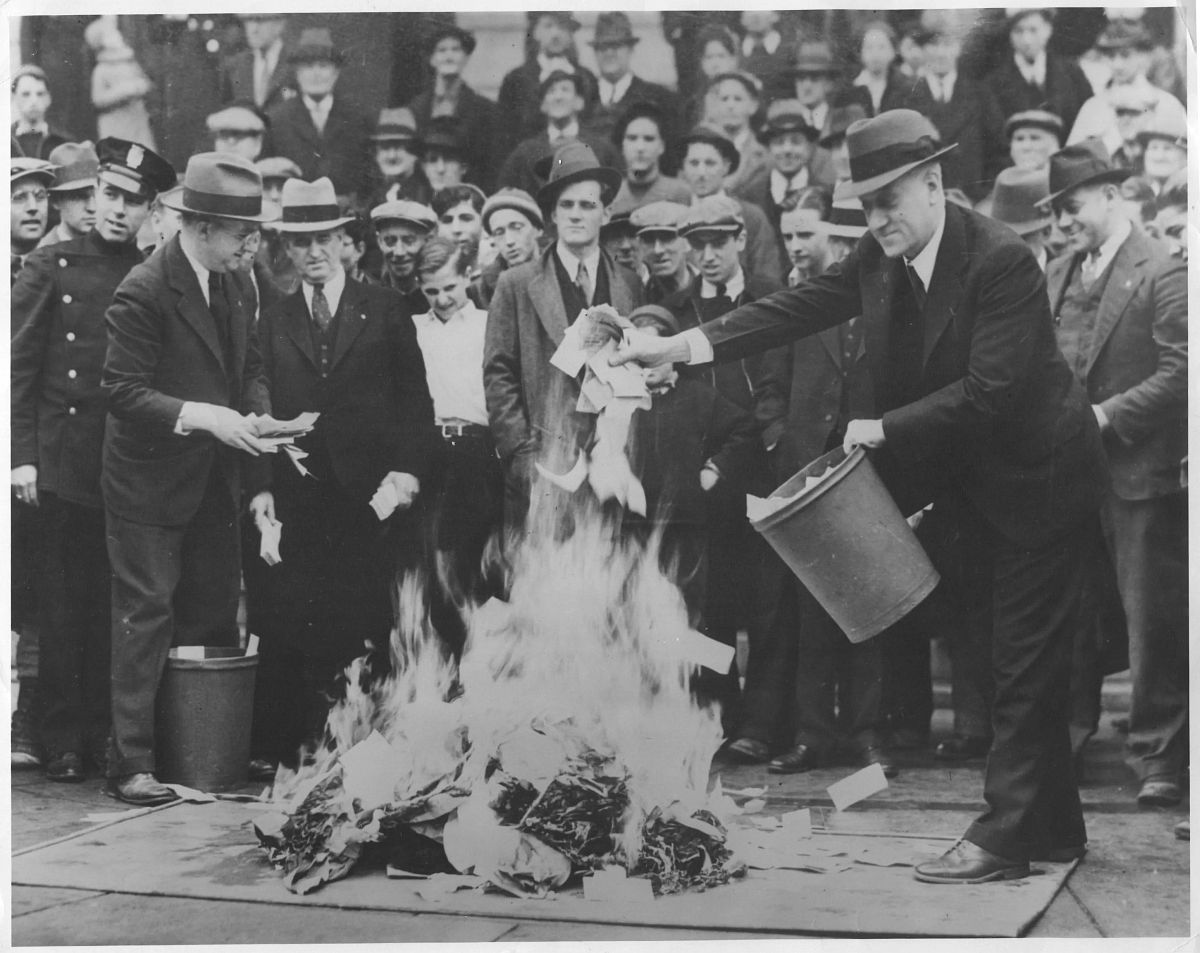 Crowds gather as hundreds of thousands of dollars in “Scrip Money” are burned. The notes were issued after the bank had closed. April, 1933