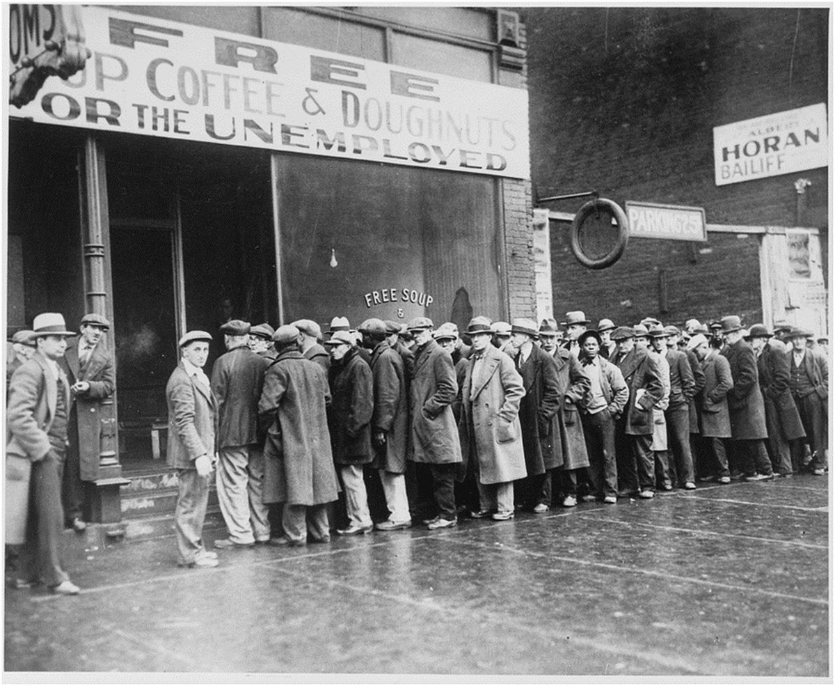 Unemployed men queued outside a depression kitchen opened in Chicago by Al Capone. Feb. 1931
