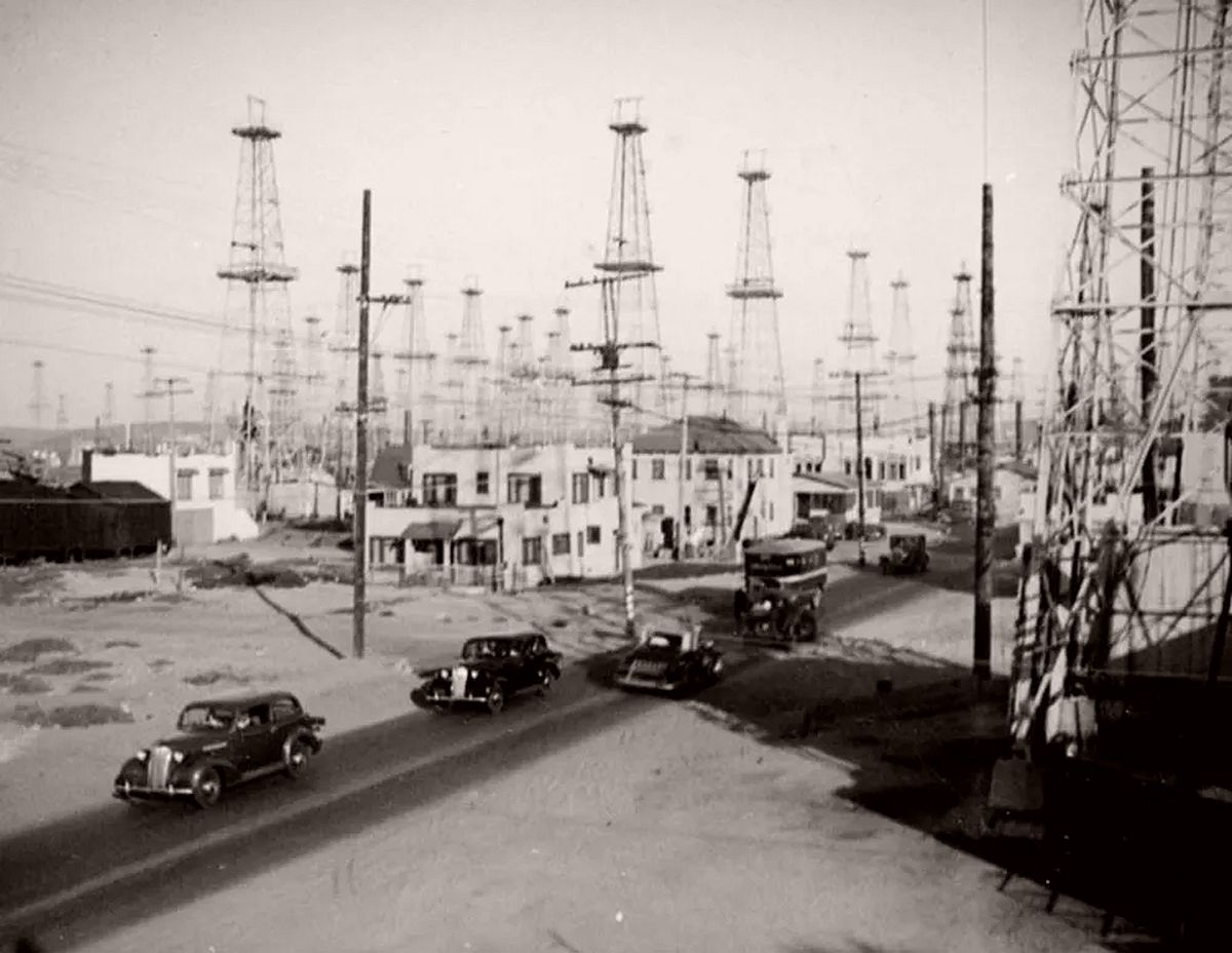 Cars travel through the Venice oilfield. 1937.