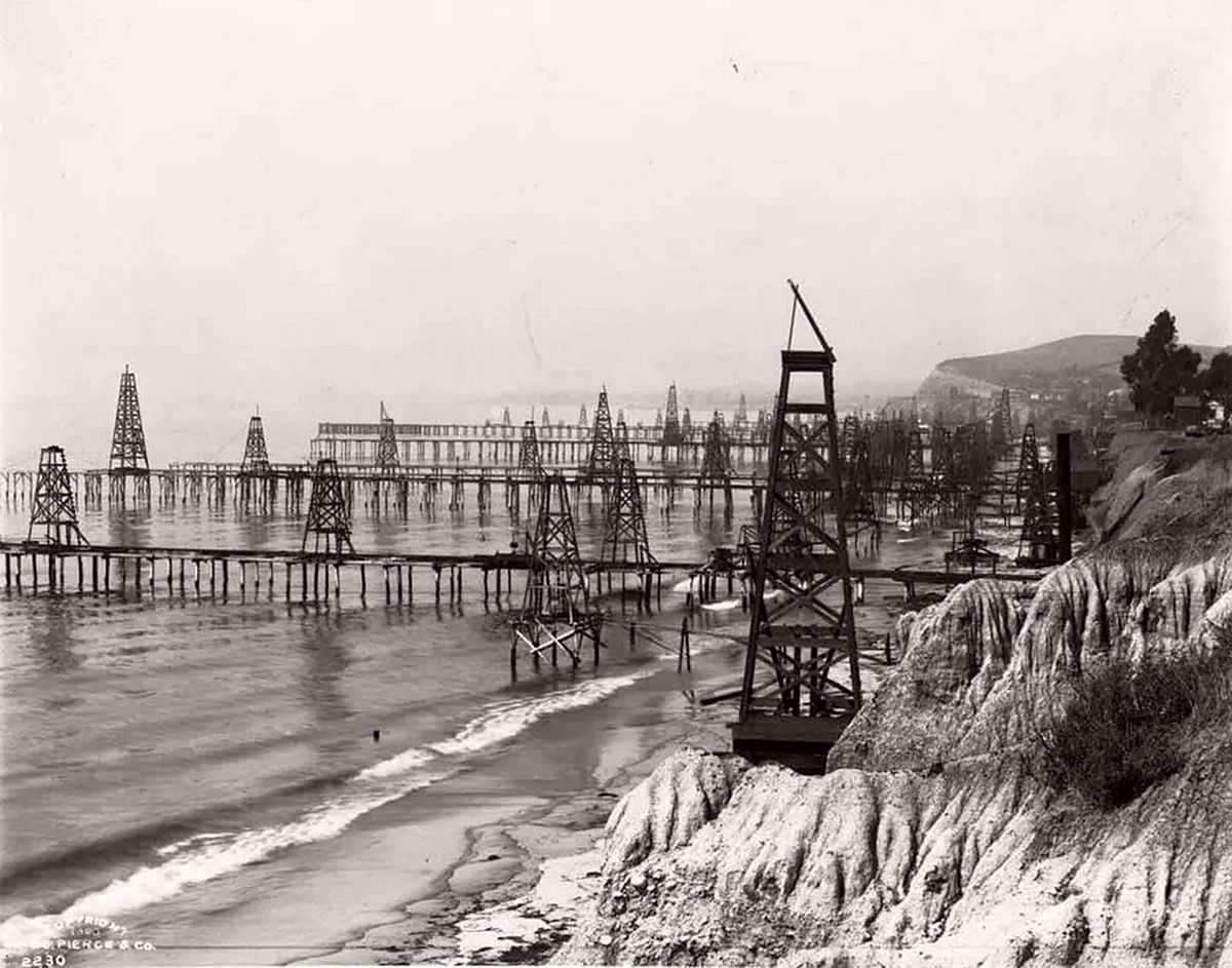 Oil derricks extending into the Pacific at Summerland Beach near Santa Barbara. 1903.