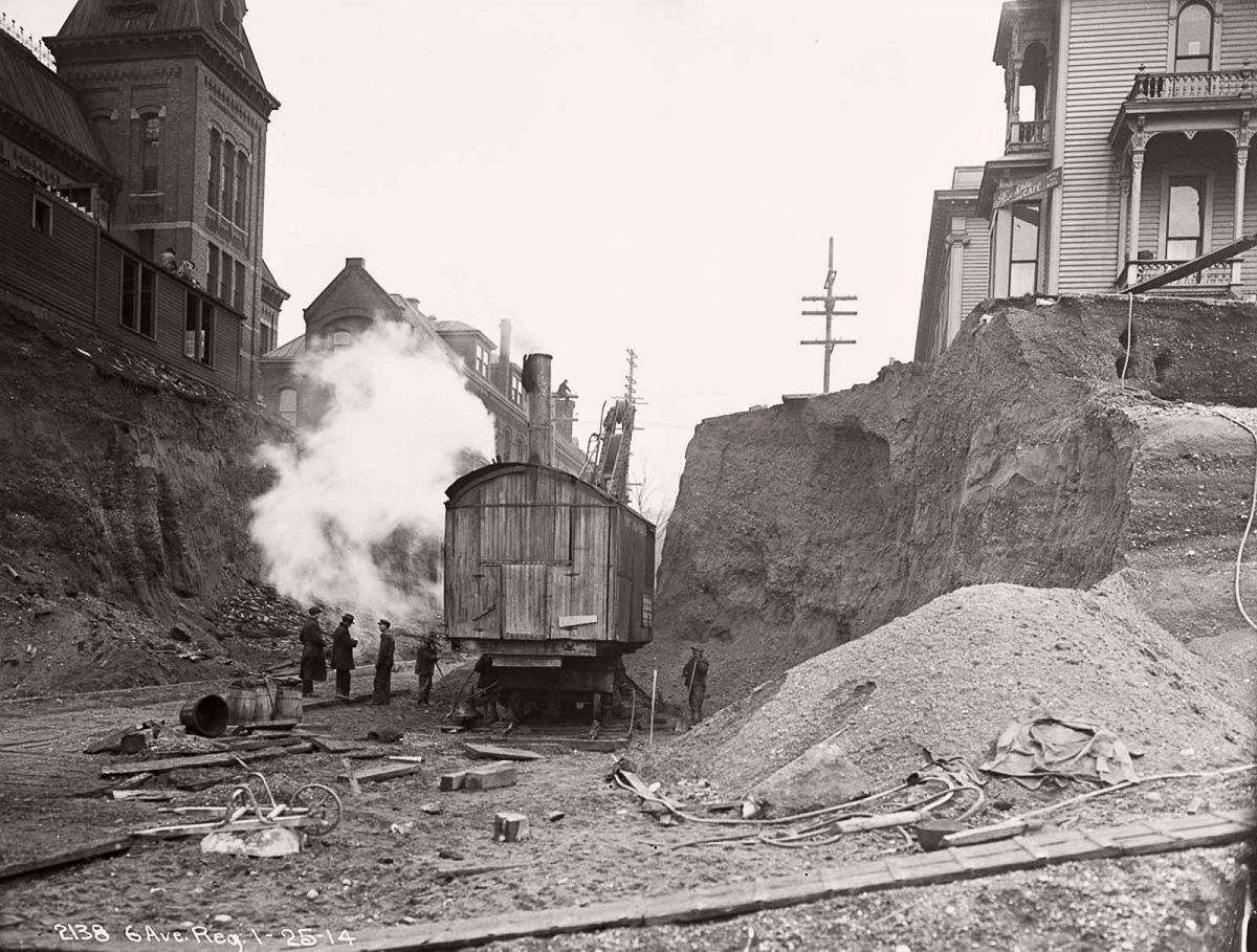 A steam shovel digs on Marion Street during the Sixth Avenue regrade. 1914.