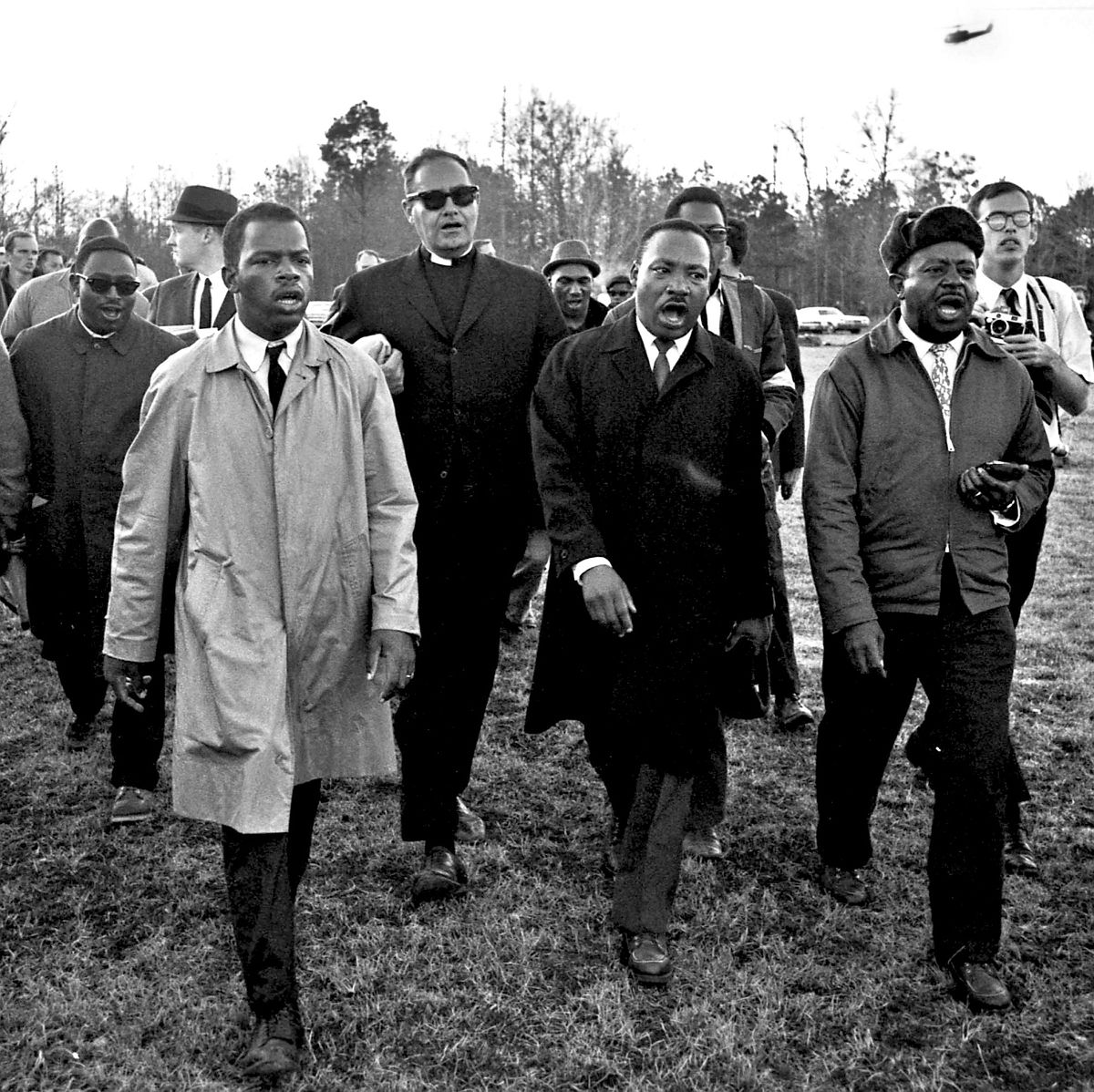 John Lewis, Dr. Martin Luther King, Jr., & Ralph Abernathy singing “We Shall Overcome” on the James Meredith March Against Fear, Mississippi, June 1966 © Harry Benson: Four Stories