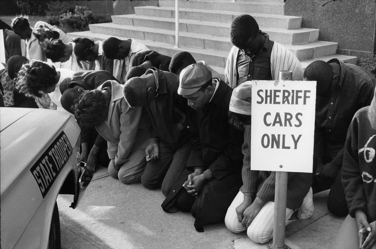Young voting rights demonstrators praying outside the Dallas County Courthouse, Selma, Alabama, March 1965, 1965