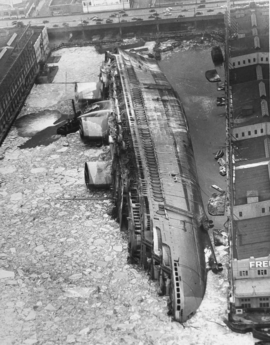 Normandie, renamed USS Lafayette, lies capsized in the frozen mud of her New York pier in the winter of 1942